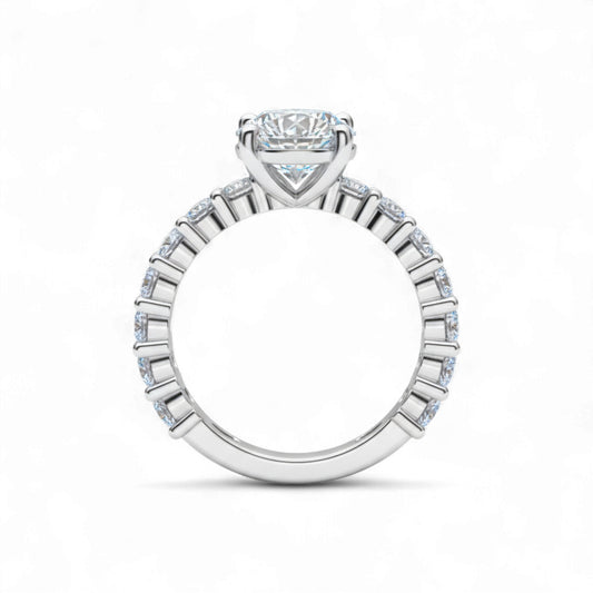 Diamond ring with a central gemstone and smaller stones on a white background