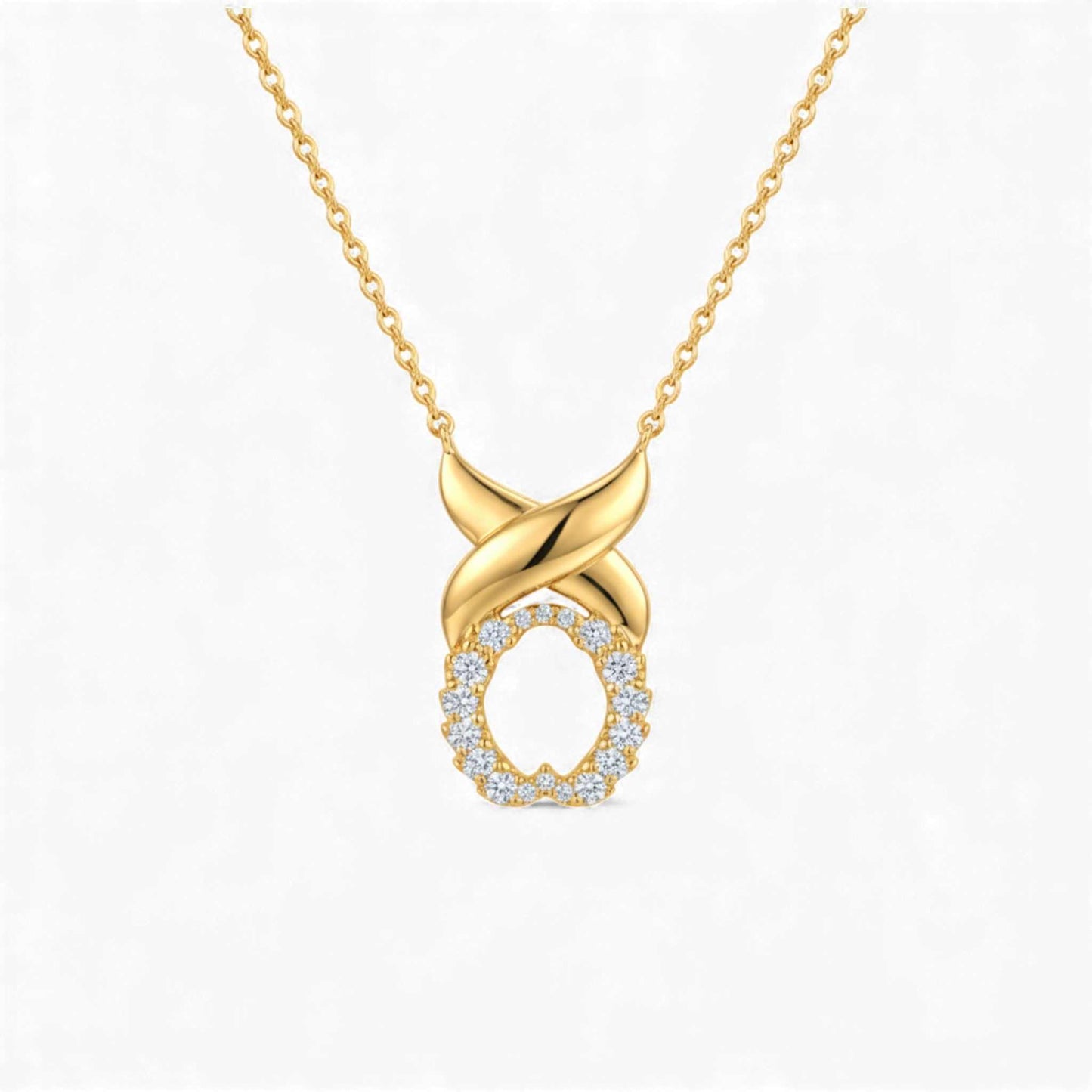 Gold necklace with a diamond-encrusted pendant on a white background