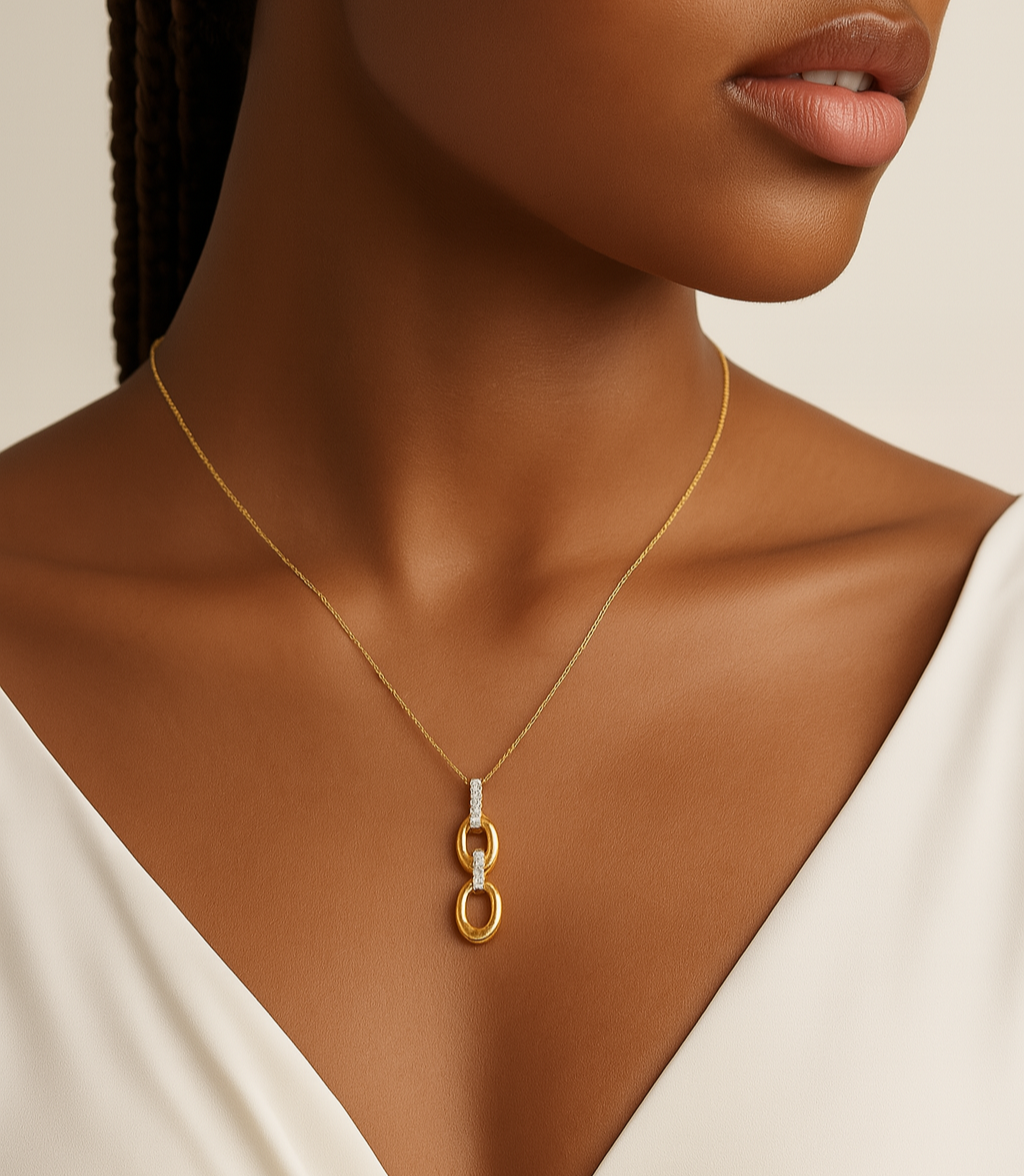 Woman wearing a gold necklace with a minimalistic pendant on a neutral background