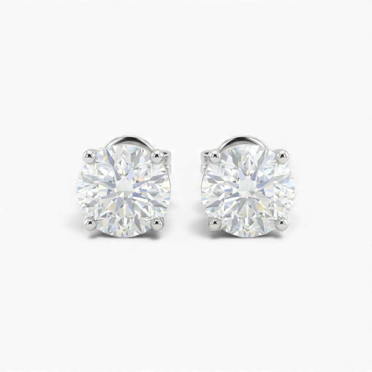 Pair of diamond stud earrings on a white background
