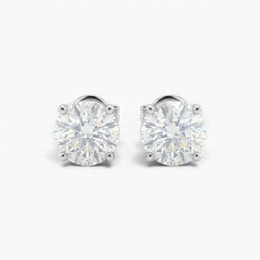 Pair of diamond stud earrings on a white background