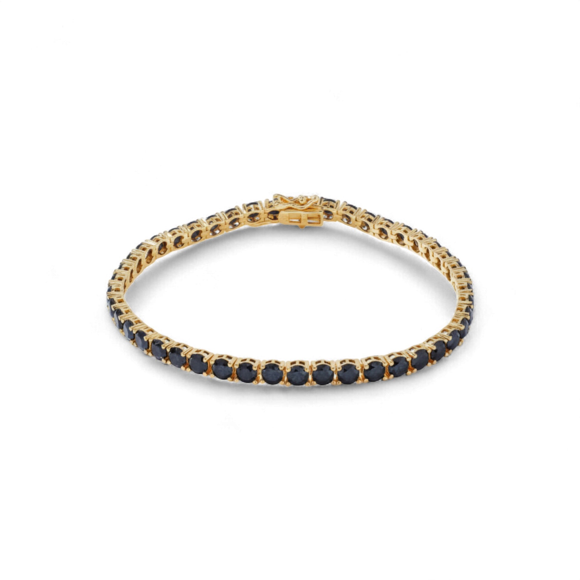 Gold bracelet with black stones on a white background