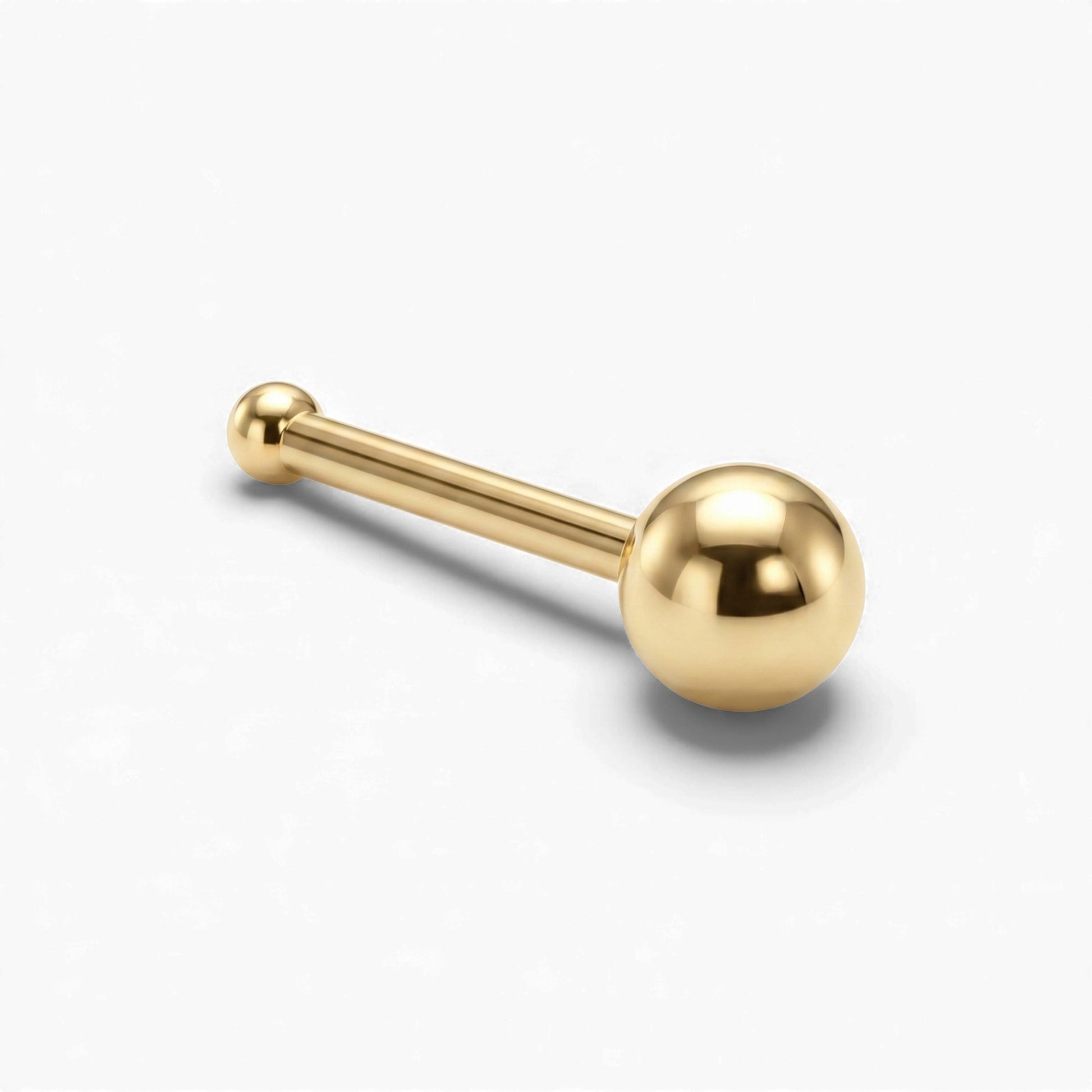 Gold barbell with spherical ends on a white background