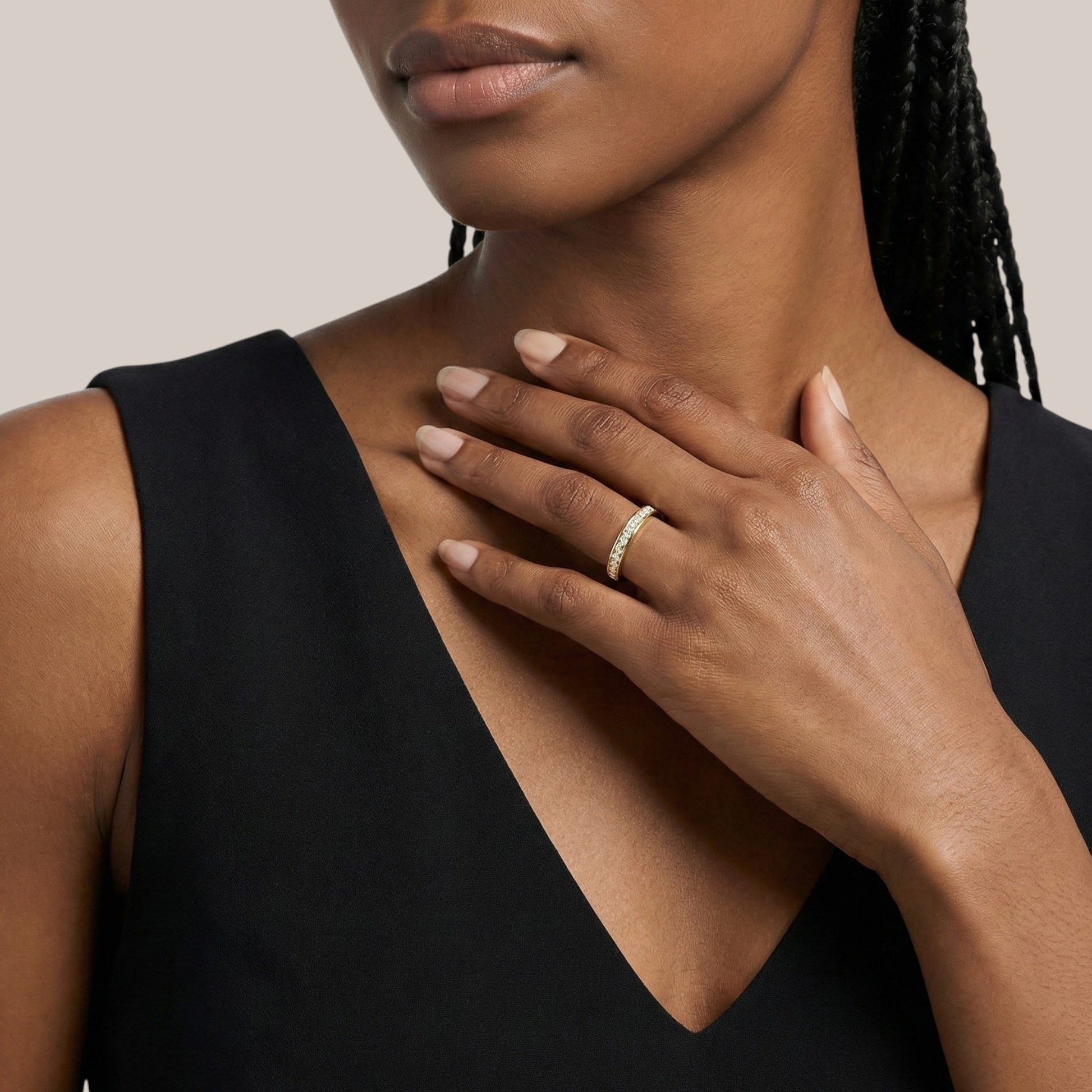 Woman wearing a black sleeveless top with a neutral background