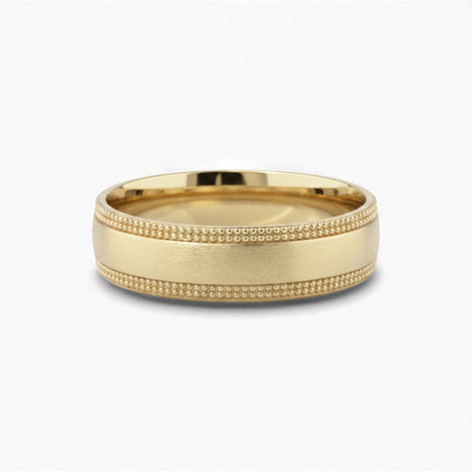 Gold ring with textured band on a white background