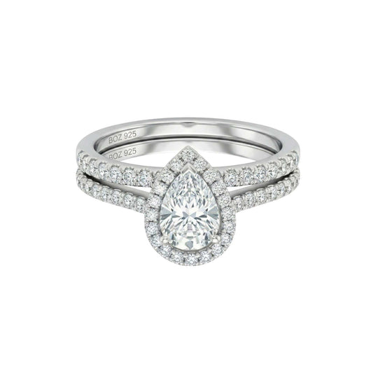 Diamond ring with a pear-shaped center stone on a white background