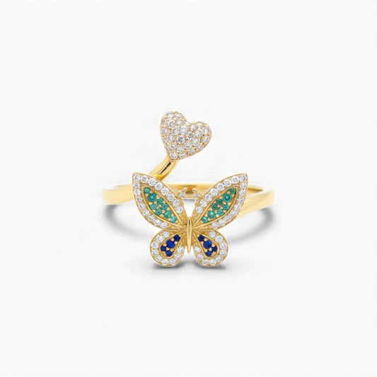 Gold butterfly ring with gemstones on a white background