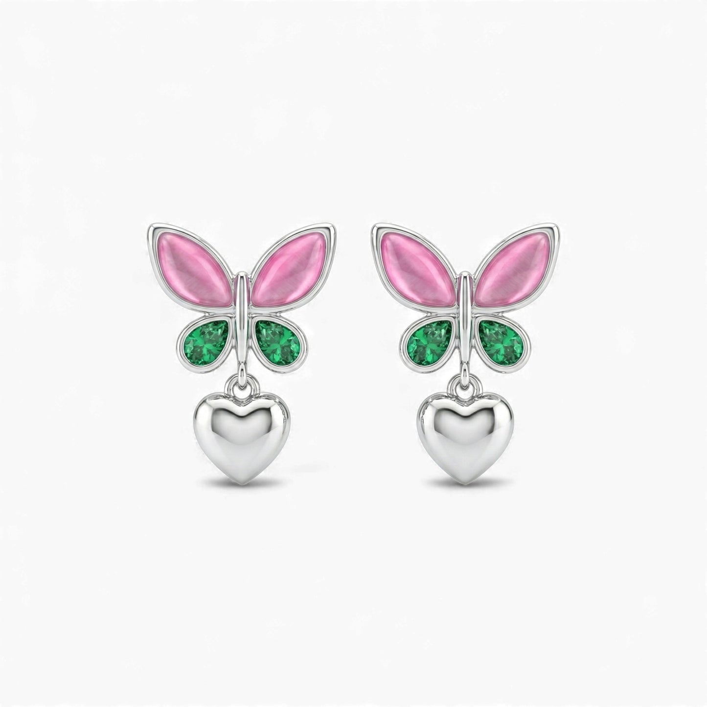 Butterfly-shaped earrings with pink wings and green gemstones on a white background