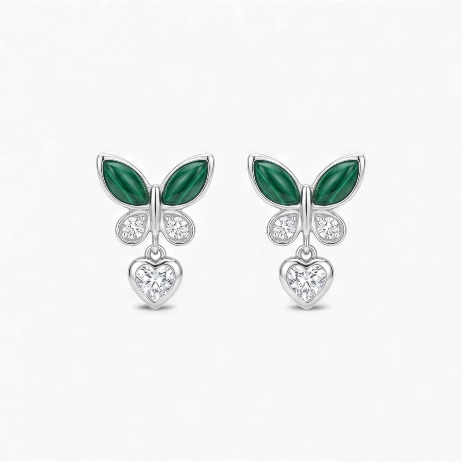 Pair of earrings with green leaf-like designs and heart-shaped elements on a white background