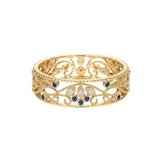 Gold ring with blue gemstones on a white background
