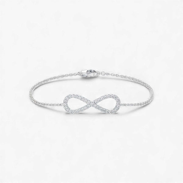Silver infinity bracelet on a light gray background