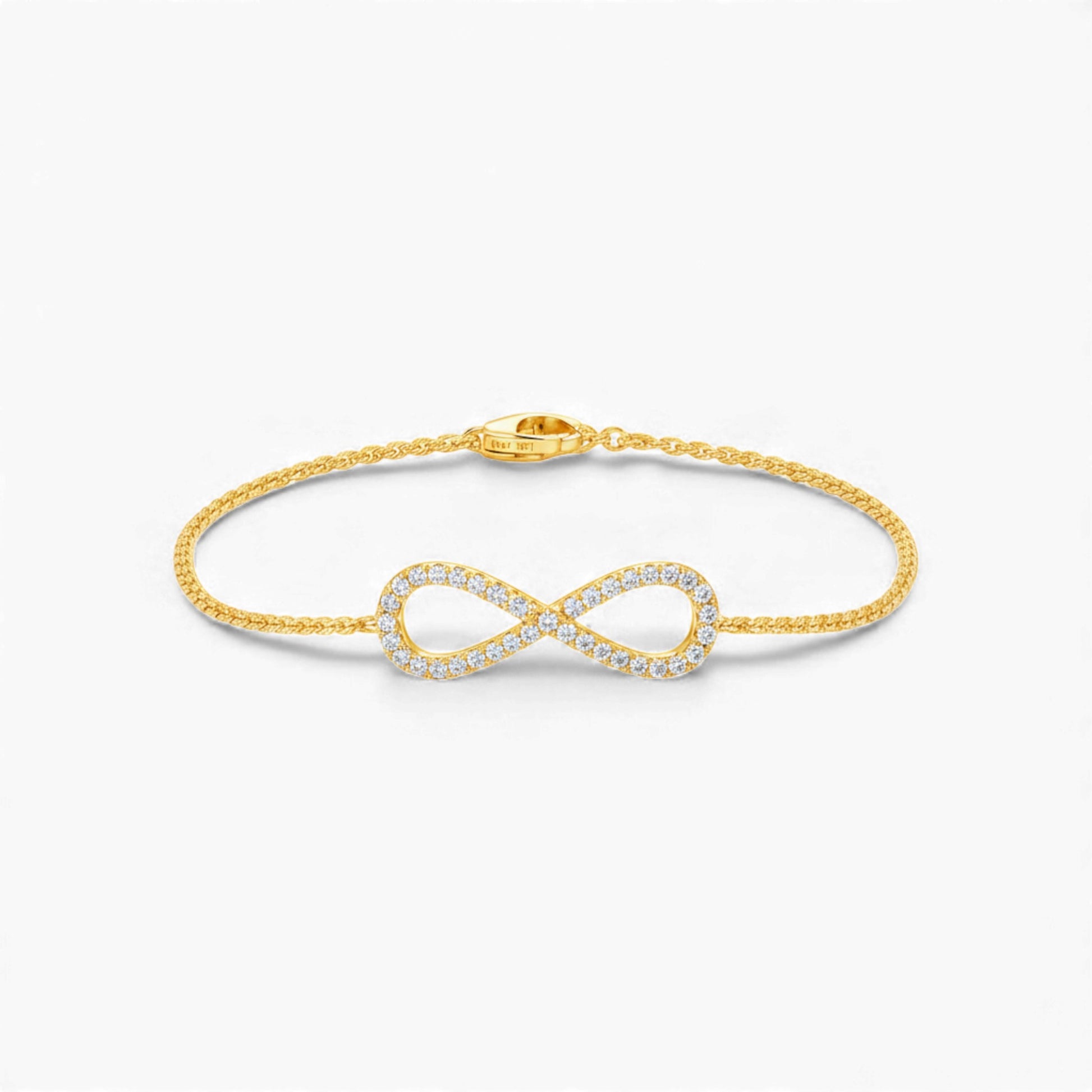 Gold infinity bracelet on a white background