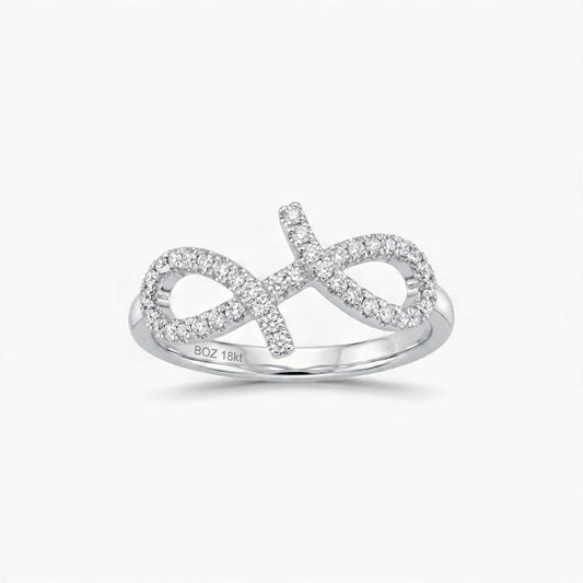 Silver infinity ring with diamonds on a white background