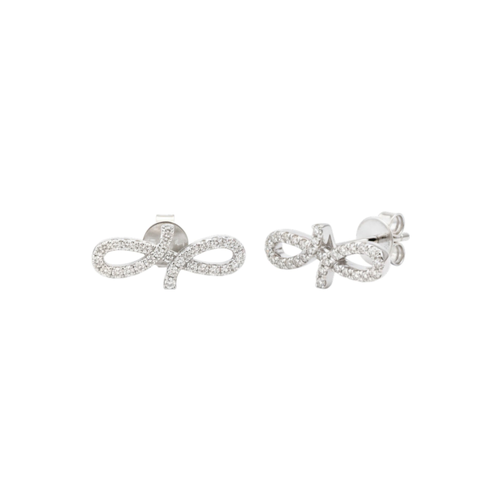 Silver bow-shaped earrings with clear stones on a white background