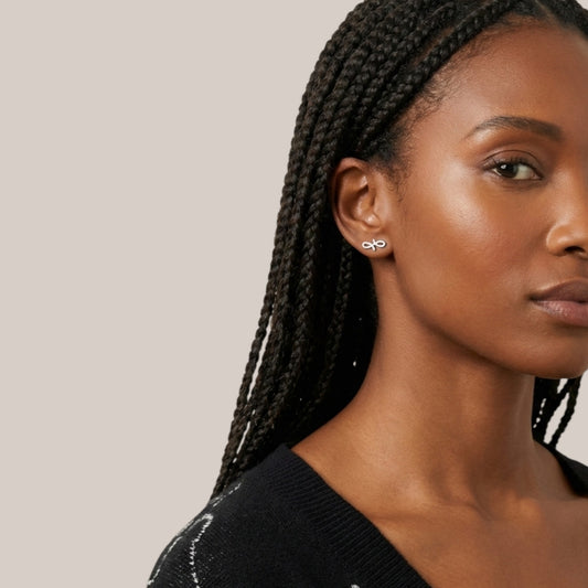 Woman wearing earrings with a neutral background