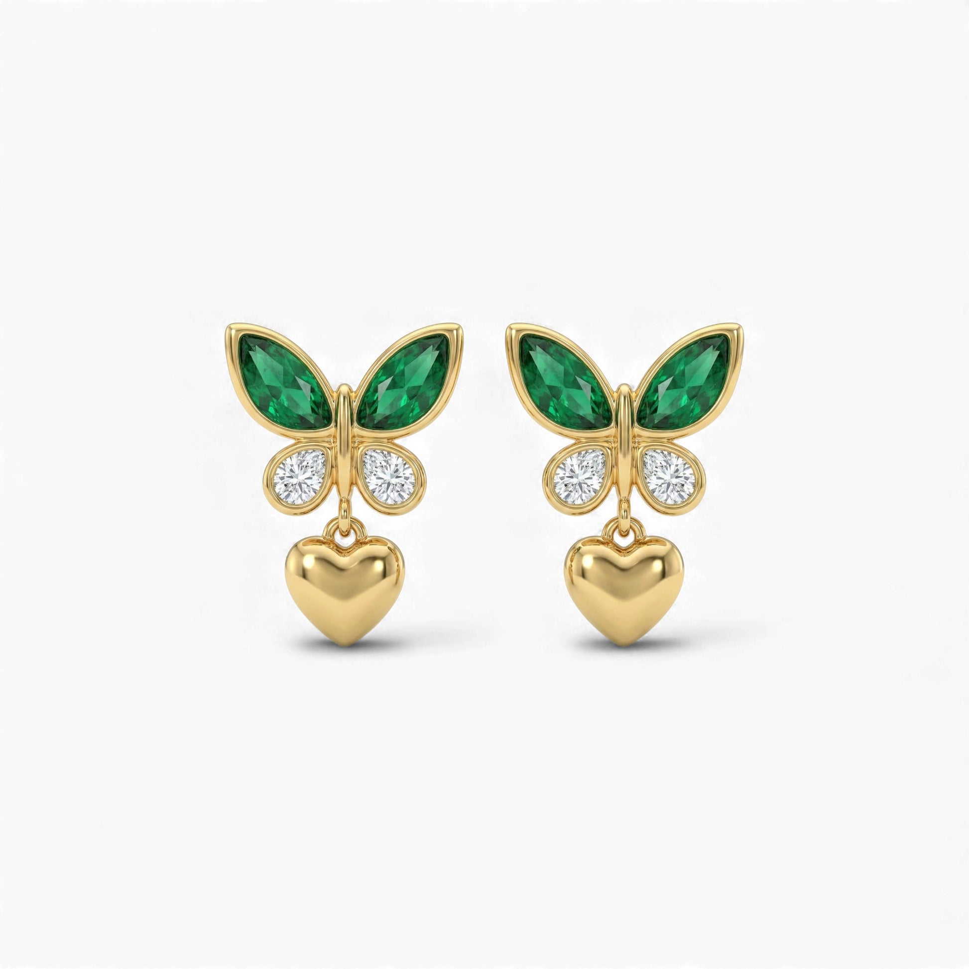 Gold butterfly earrings with green gemstones and heart pendants on a white background