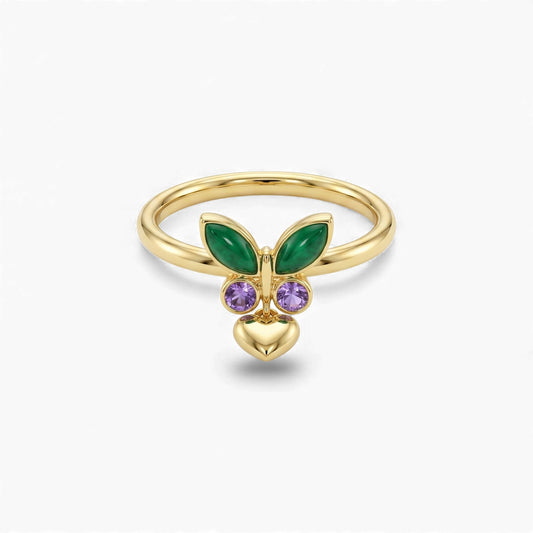 Gold ring with green and purple gemstones on a white background