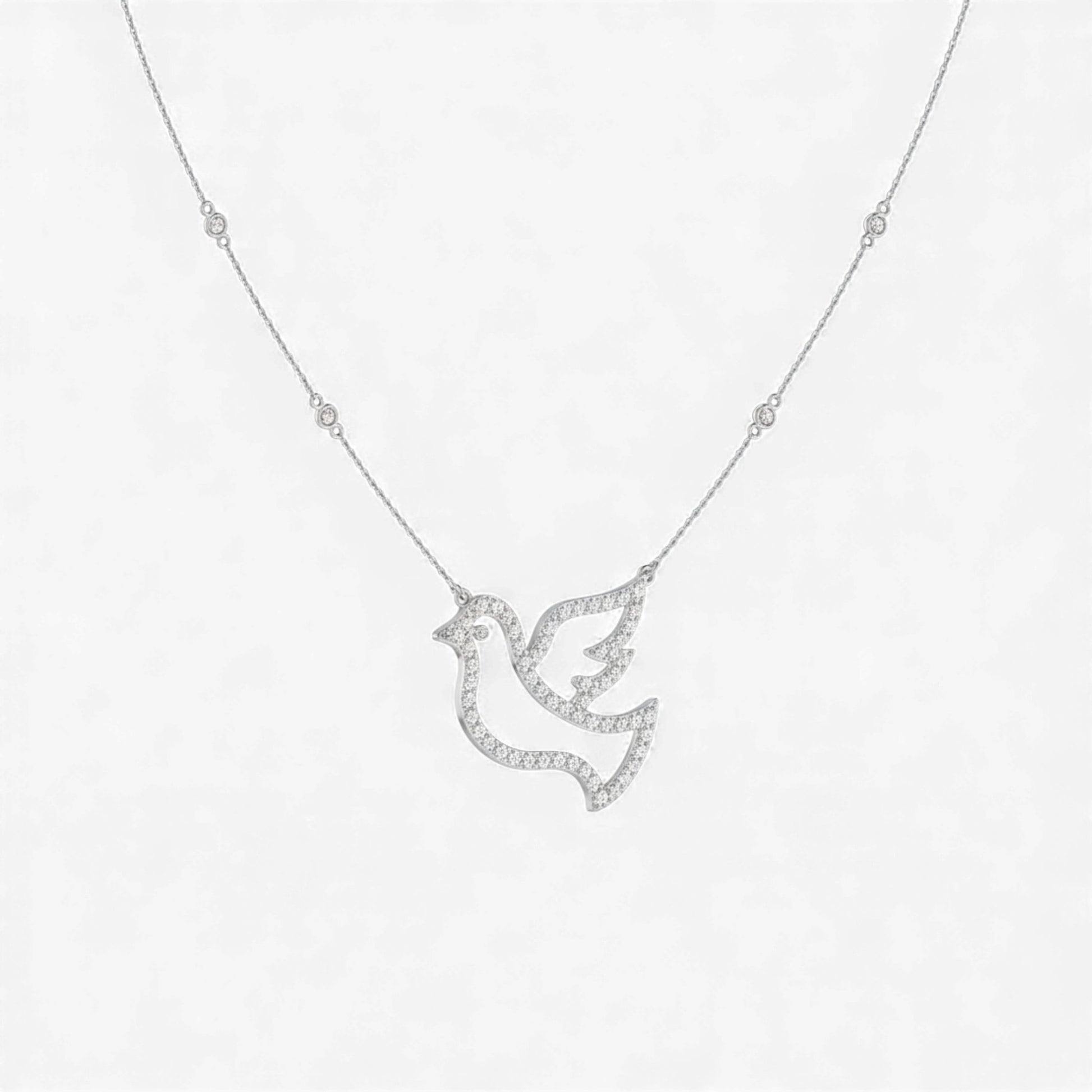 Silver dove-shaped pendant necklace on a white background