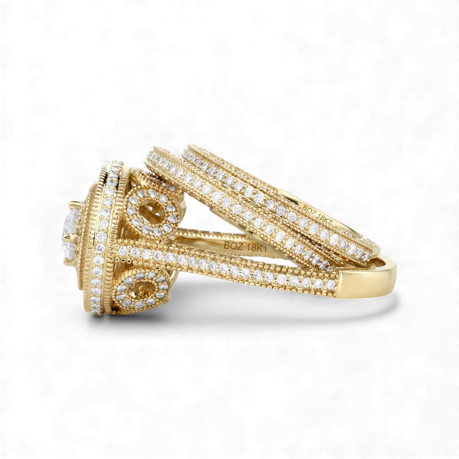 Gold ring with diamond accents on a white background