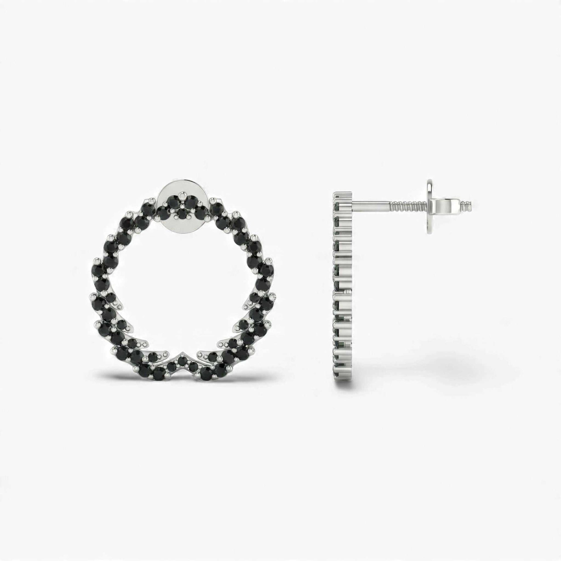 Hoop earrings with black gemstones on a white background