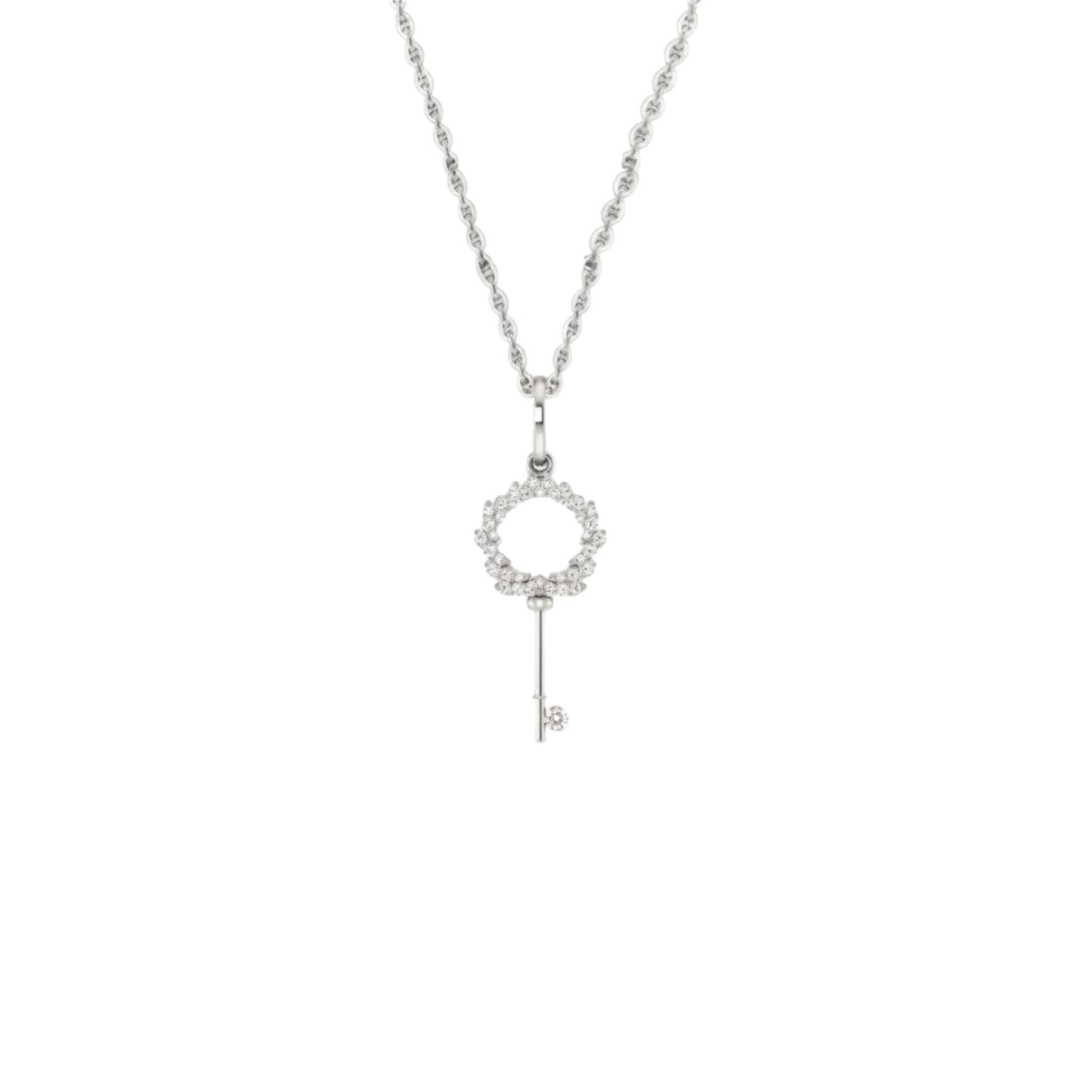 Silver key-shaped pendant necklace on a white background