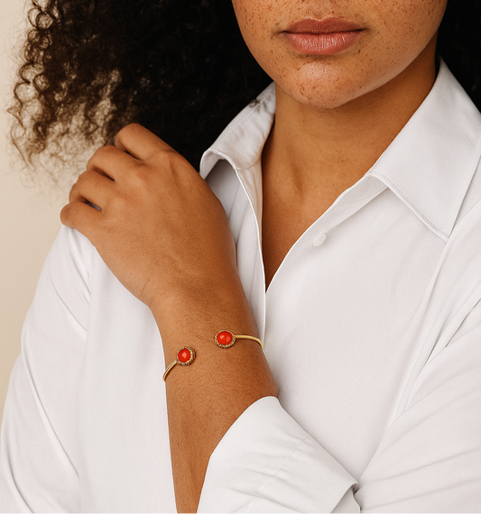 Woman wearing a white shirt with a red bracelet on a beige background