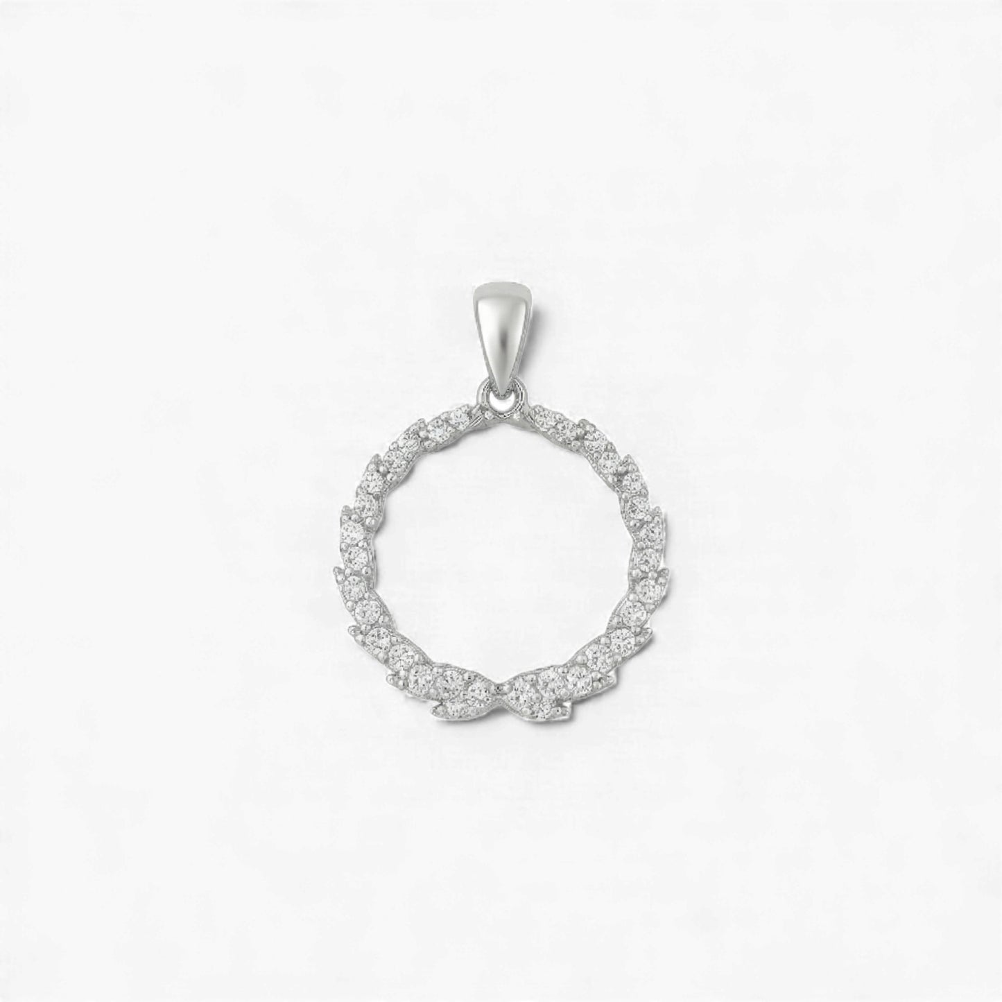 Silver circular pendant with small diamonds on a light gray background