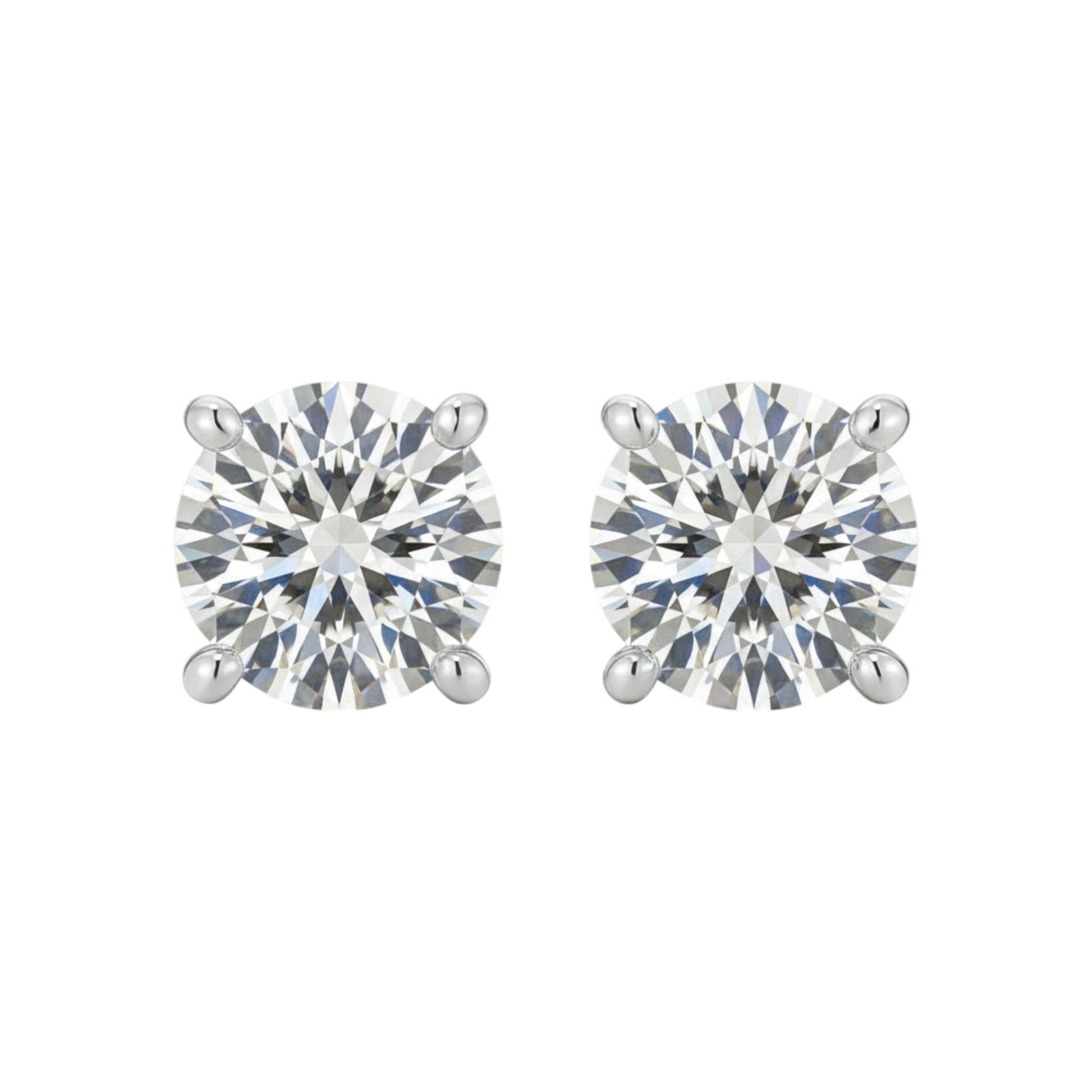 Pair of round diamond stud earrings on a white background