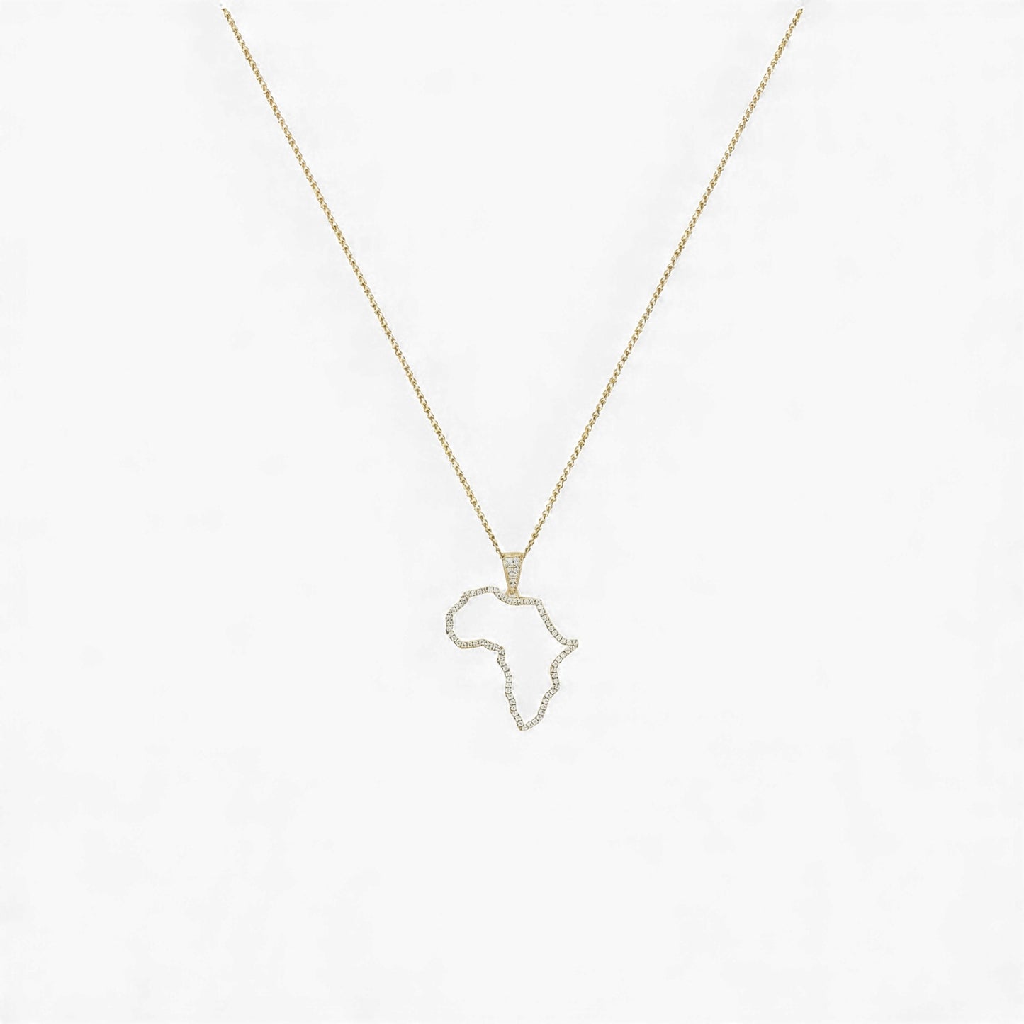 Gold necklace with a pendant shaped like the African continent on a light gray background