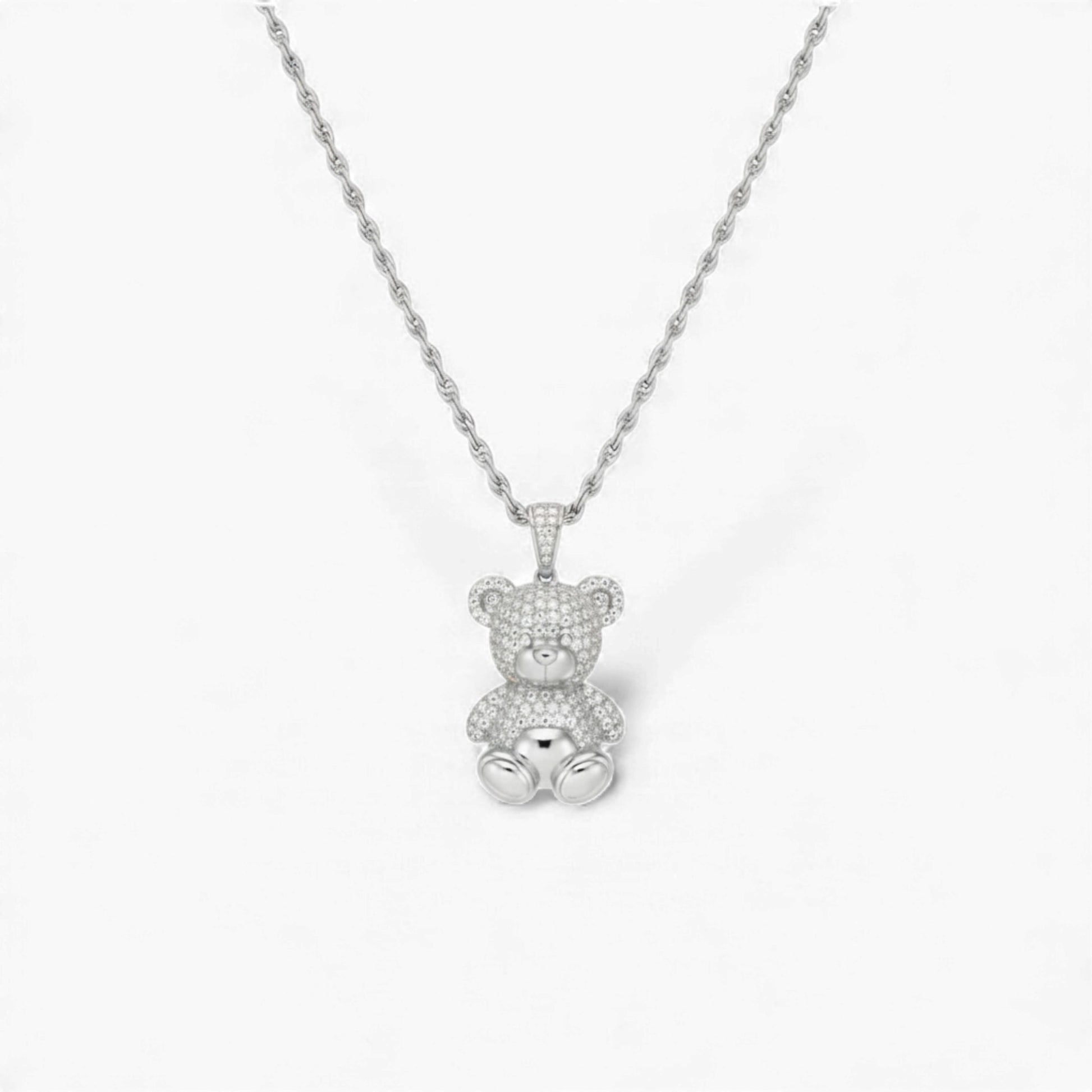 Silver teddy bear pendant necklace on a white background