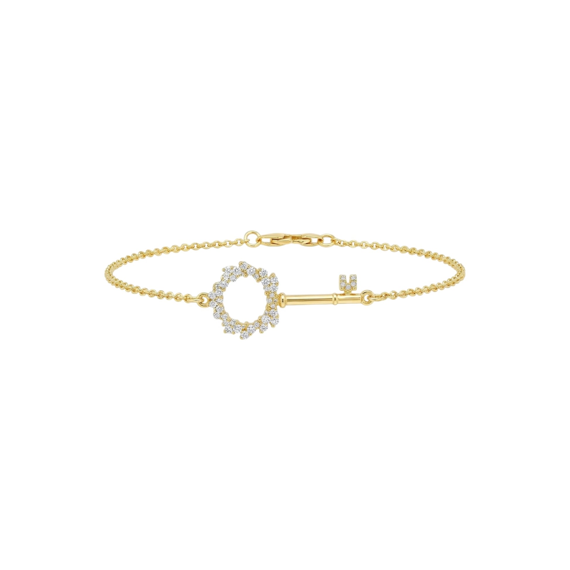 Gold bracelet with a key-shaped clasp on a white background