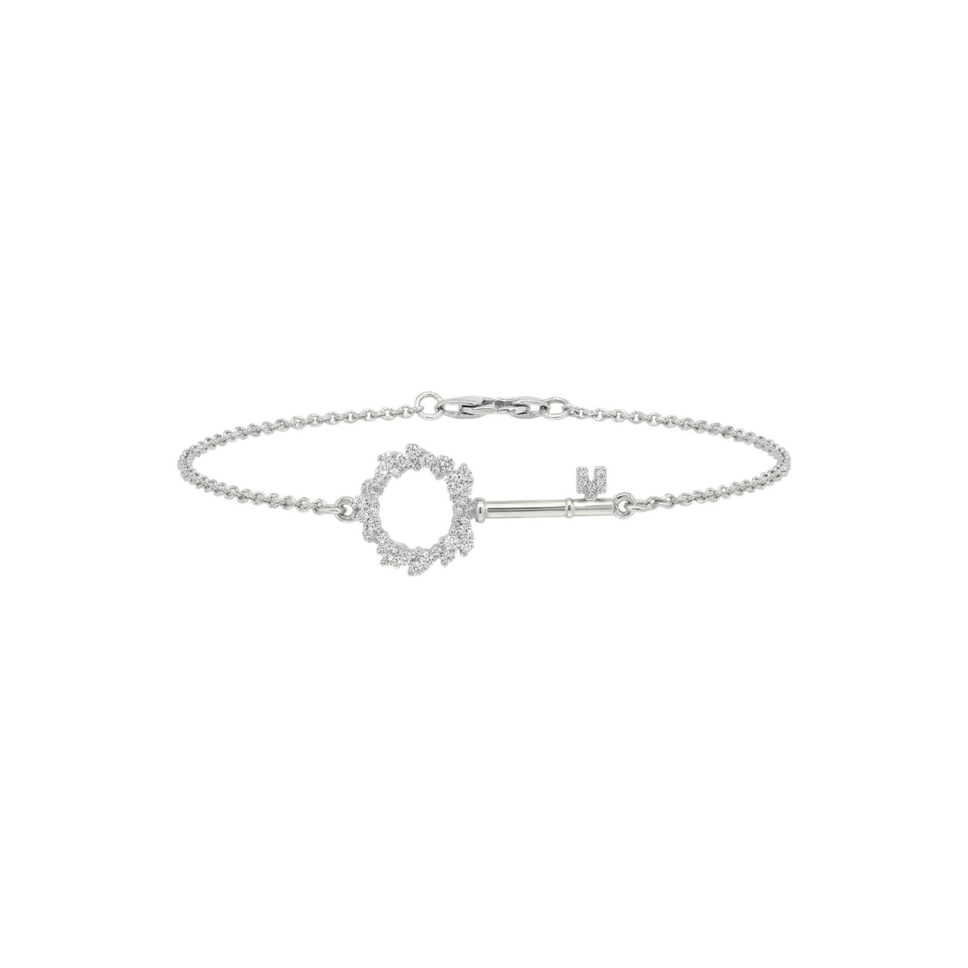 Silver bracelet with a key-shaped clasp on a white background