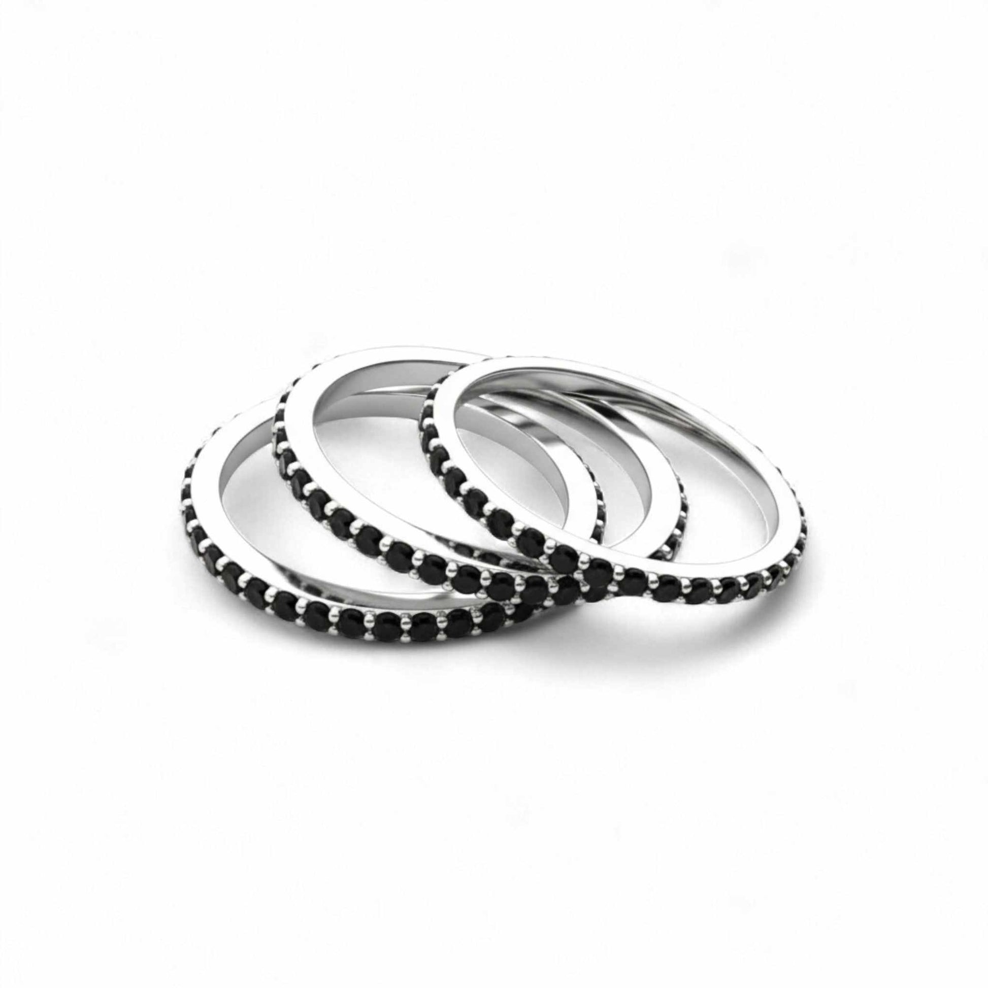 Set of silver and black beaded bracelets on a white background