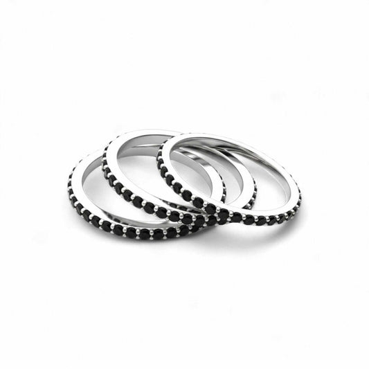 Set of silver and black beaded bracelets on a white background