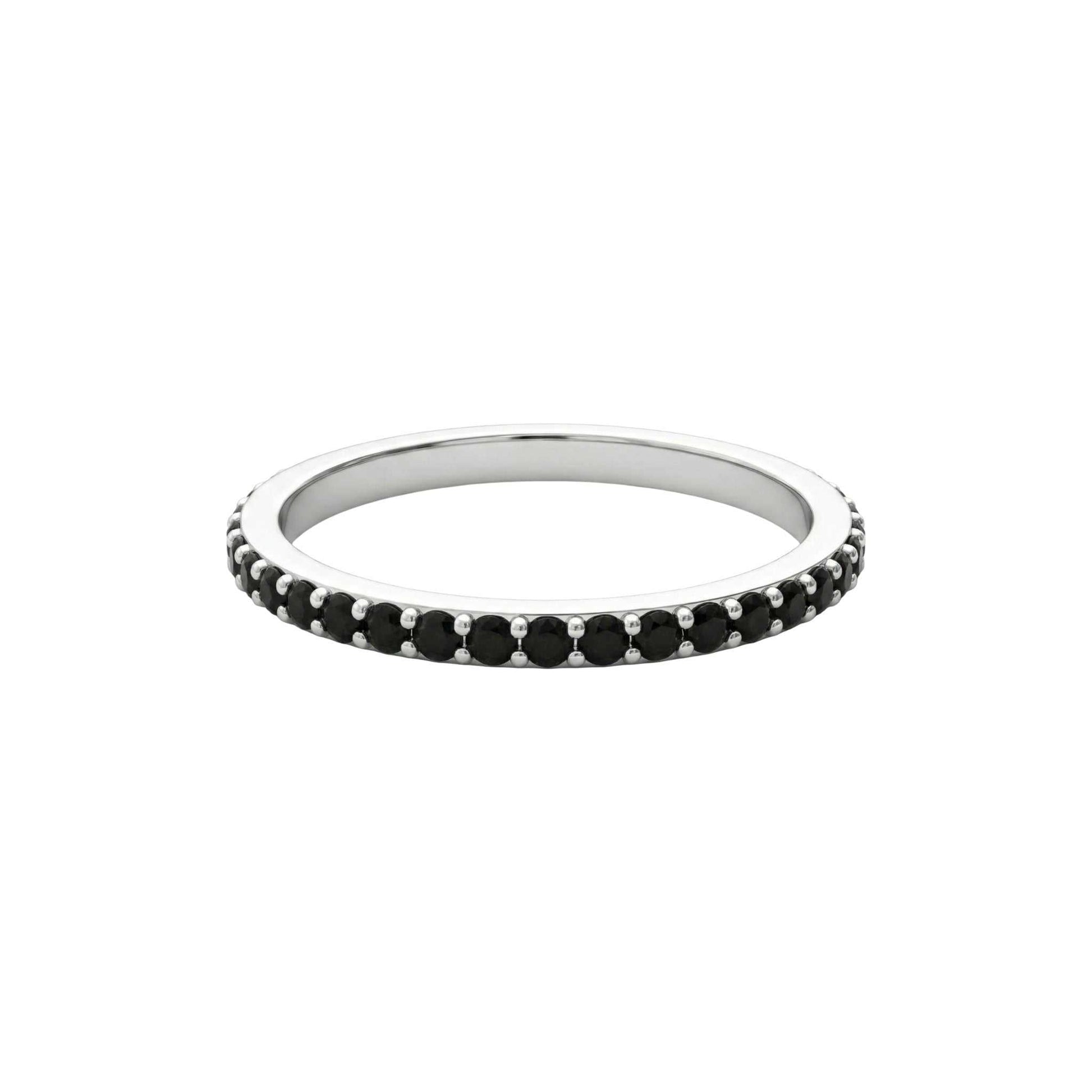 Silver ring with black gemstones on a white background