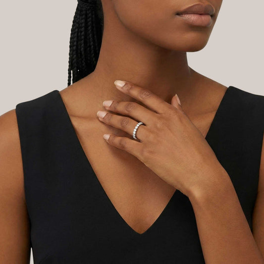 Woman wearing a black sleeveless top with a neutral background