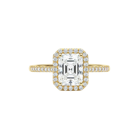 Gold ring with a large diamond and smaller diamonds on the band against a white background