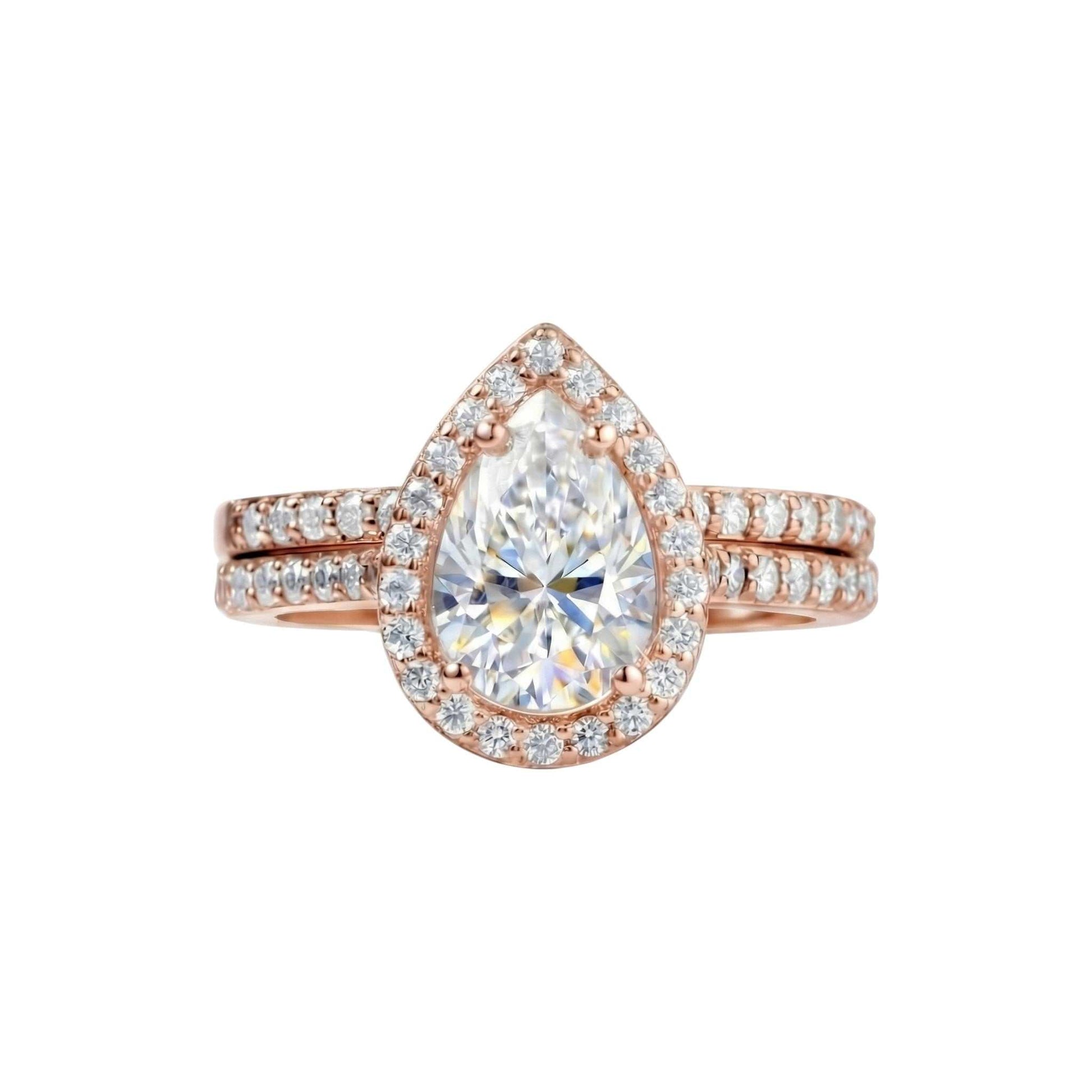Classic Pear Cut Moissanite bridal ring set in 18KT gold with teardrop shaped gemstone and diamond accents