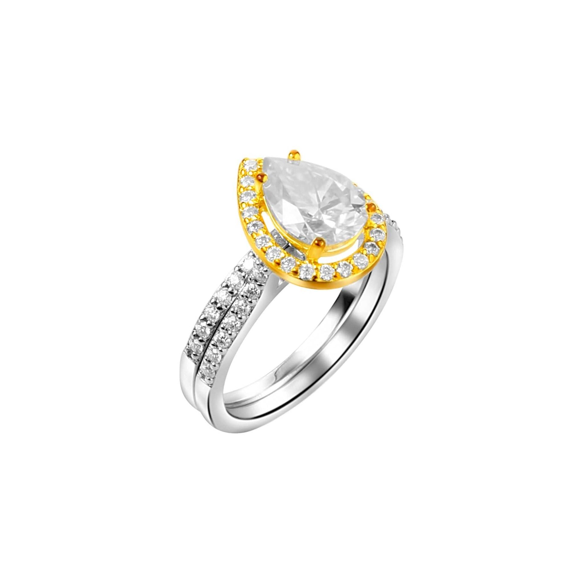Ring with a pear-shaped center stone and gold halo on a white background