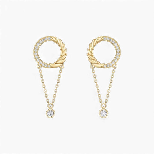 Gold earrings with circular designs and chain details on a white background