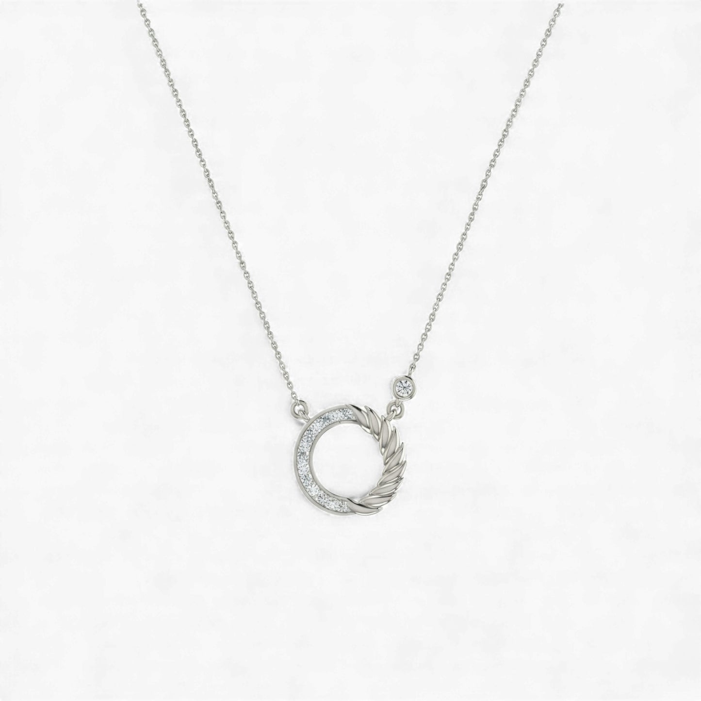Silver necklace with a circular pendant on a white background