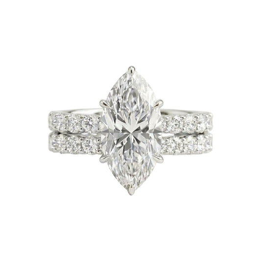 Diamond ring with pear-shaped center stone on a white background