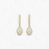 Gold teardrop earrings with clear gemstones on a white background