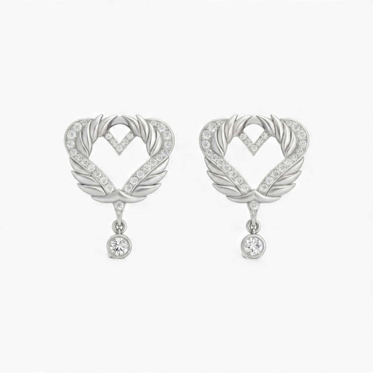 Heart-shaped earrings with feather designs and small crystals on a white background