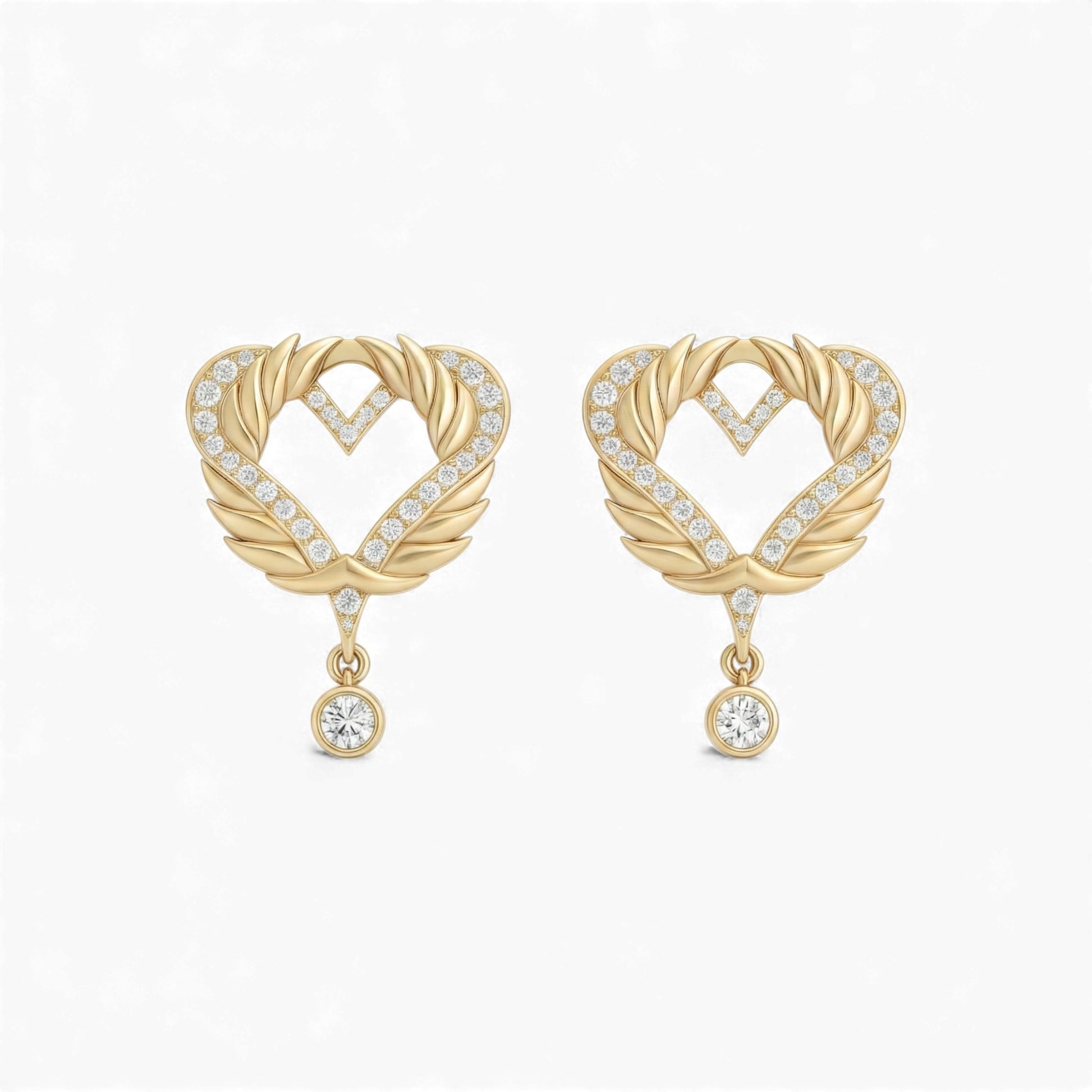 Gold heart-shaped earrings with diamond accents on a white background