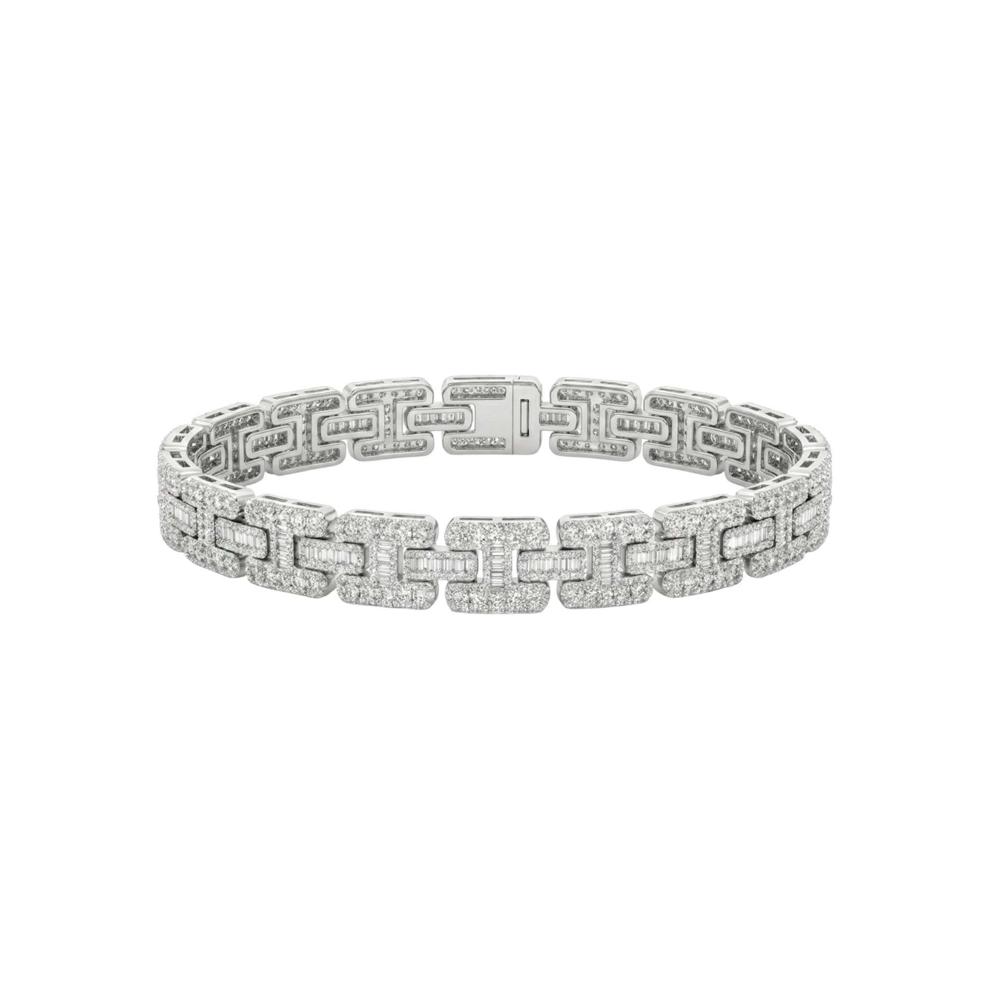 Silver bracelet with diamond accents on a white background