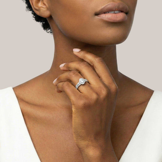 Woman wearing a diamond ring on her hand with a neutral background