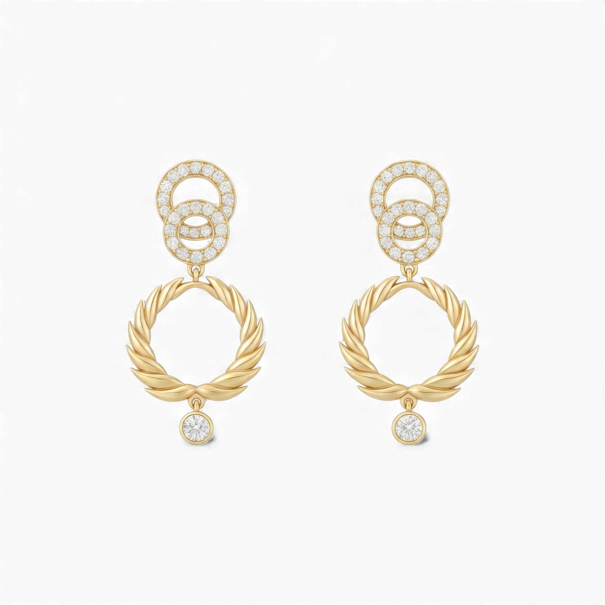 Gold earrings with interlocking rings and small diamonds on a white background