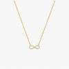 Gold infinity necklace on a white background