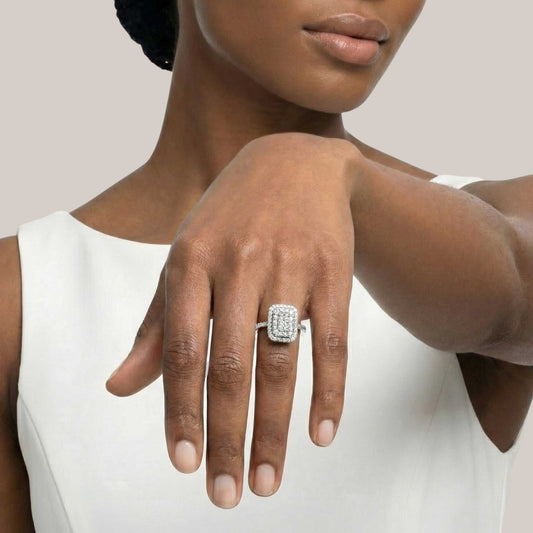 Woman wearing a diamond ring on her hand against a neutral background